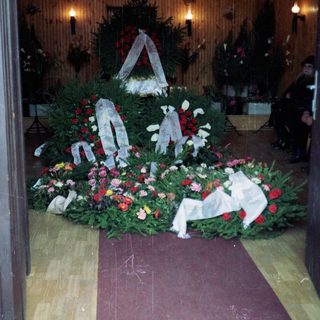 Memorial wreaths and flowers arranged at a funeral.