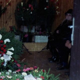 Memorial wreaths and flowers arranged at a funeral.