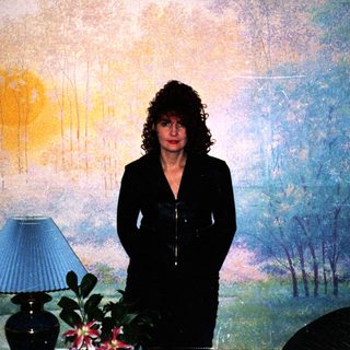 Woman standing in front of large landscape mural.
