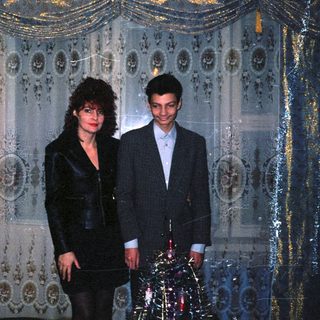 Two people dressed formally in an ornate indoor setting.
