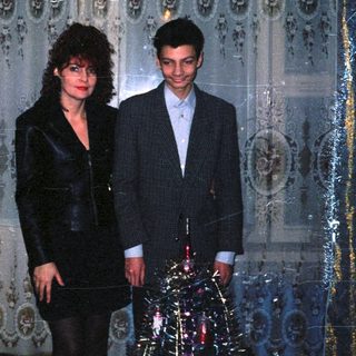 Two people dressed formally in an ornate indoor setting.