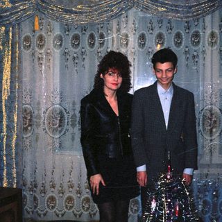 Two people dressed formally in an ornate indoor setting.