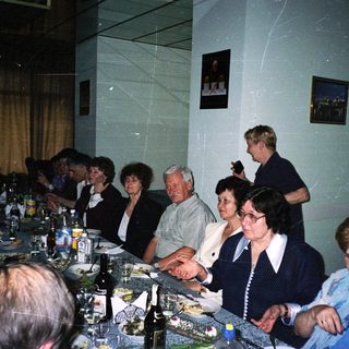Group of people gathered for a formal dinner party.