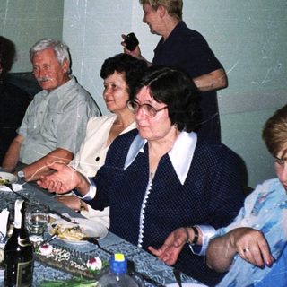 Group of people gathered for a formal dinner party.
