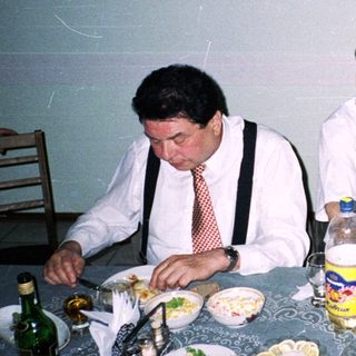 Four adults dining together at a festive table.