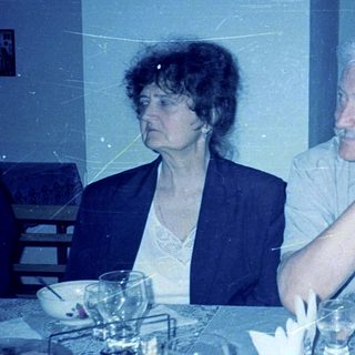 Two people seated at a dining table.