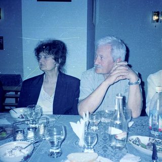 Two people seated at a dining table.