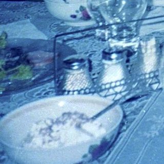 Two people seated at a dining table.