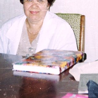 Office setting with woman seated at desk.
