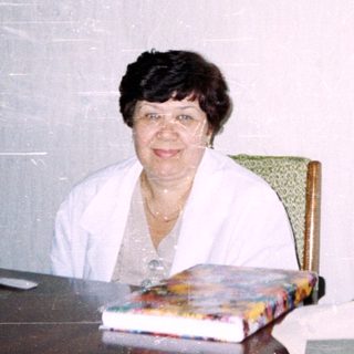 Office setting with woman seated at desk.