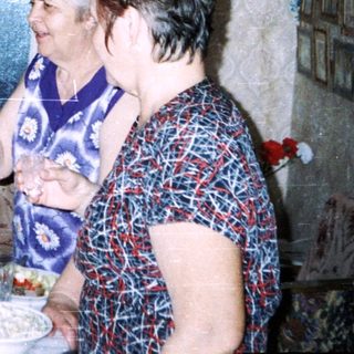 Family gathering indoors with drinks and food.