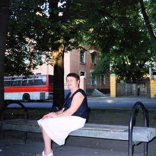 Woman sitting alone on park bench.