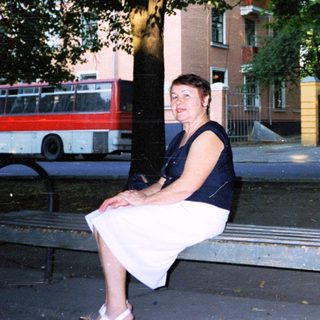 Woman sitting alone on park bench.