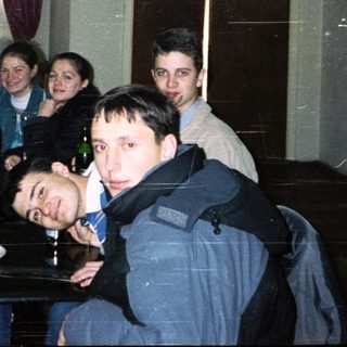 Group of people gathered indoors for a casual meal or gathering.