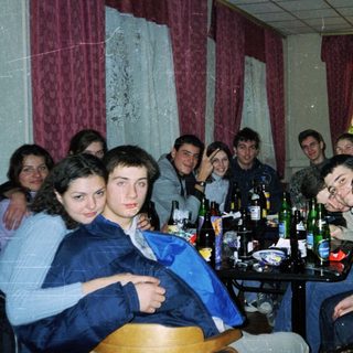 Group of young people gathered indoors for a social gathering.