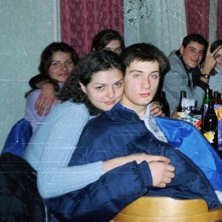Group of young people gathered indoors for a social gathering.