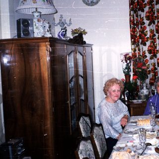 Family gathering celebrating with cake indoors.