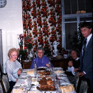 Family gathering celebrating with cake indoors.