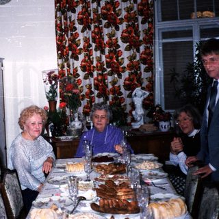 Family gathering celebrating with cake indoors.