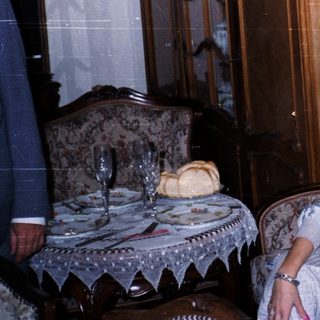 Woman sitting on vintage bed in classic interior.