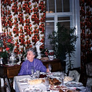 Two elderly women enjoying a festive meal together.