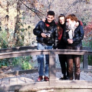 People standing on a bridge in autumn park.