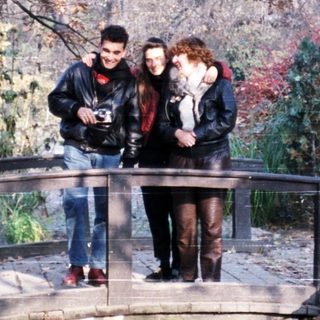 People standing on a bridge in autumn park.