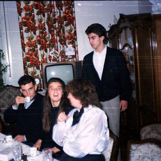 Family gathering enjoying dinner indoors.