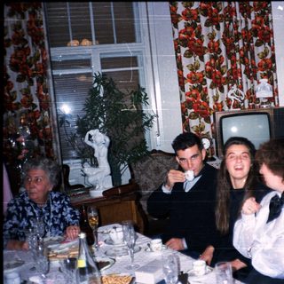 Family gathering enjoying dinner indoors.