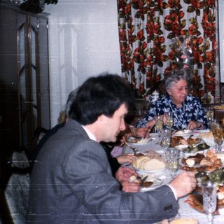 Family gathering enjoying holiday meal indoors.