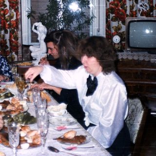 Family gathering enjoying holiday meal indoors.