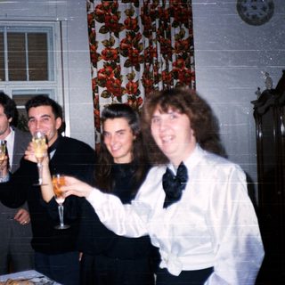Group celebrating indoors with champagne toasts.