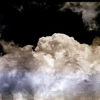 Certainly! Here's a brief summary of the image: Cloudy night sky with visible film grain and scratches.