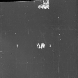 Black surface with scratches and damage near the bottom edge.