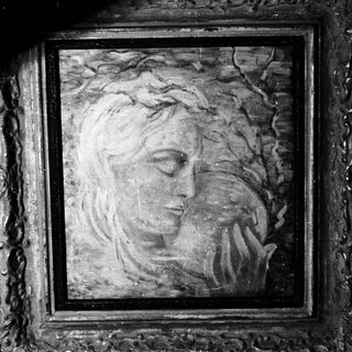 Here's a brief summary of the image: Framed portrait of a woman with closed eyes.