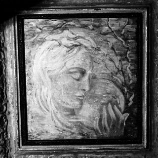 Here's a brief summary of the image: Framed portrait of a woman with closed eyes.