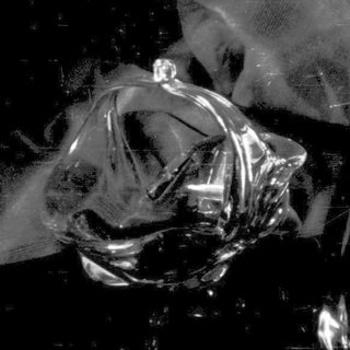 Crinkled plastic wrap against a dark, reflective surface.