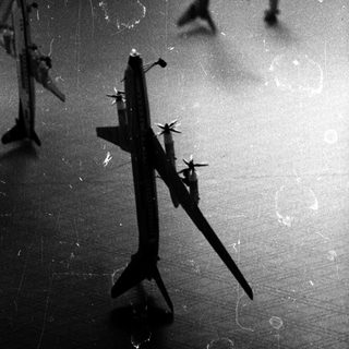 Shadows of model airplanes projected on a wall.
