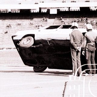 Officials inspect car on track during Olympic Games.