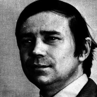 Black and white portrait of a man in a suit.