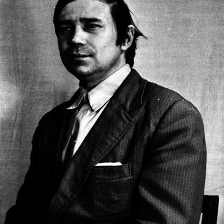 Black and white portrait of a man in a suit.