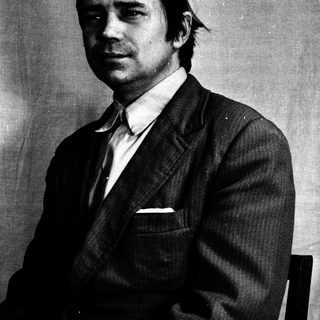 Black and white portrait of a man in a suit.