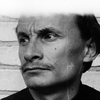Black and white portrait of a man in a suit.