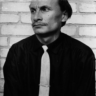 Black and white portrait of a man in a suit.