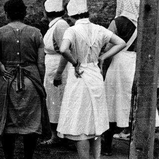 Group of women observing an excavation site.