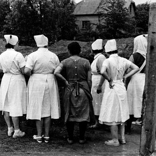 Group of women observing an excavation site.