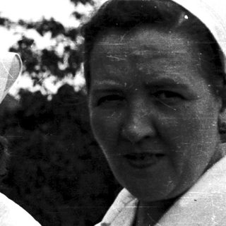 Three women in nurse uniforms outdoors, likely at a hospital.