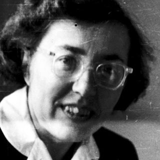 Black-and-white portrait of an older woman smiling.