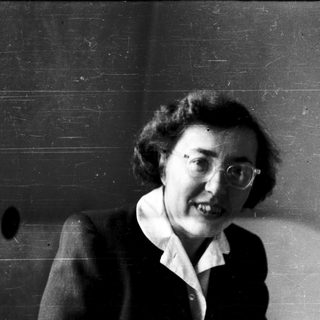 Black-and-white portrait of an older woman smiling.