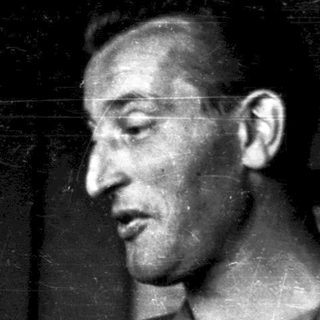 Black-and-white portrait of a man indoors.
